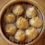 Delicious steamed chicken soup dumplings served in a bamboo steamer